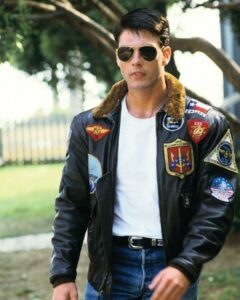 Tom Cruise wearing his iconic Maverick celebrity leather jacket bomber from Top Gun.